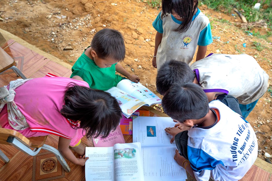 Group of children exploring educational books outdoors, fostering curiosity and learning