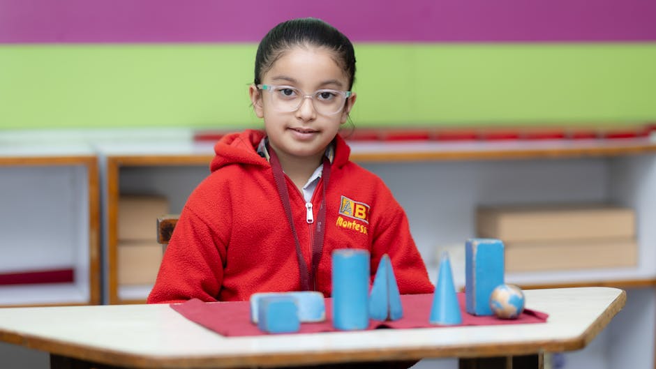 Young girl in red sweater explores geometric shapes in a Montessori classroom setting