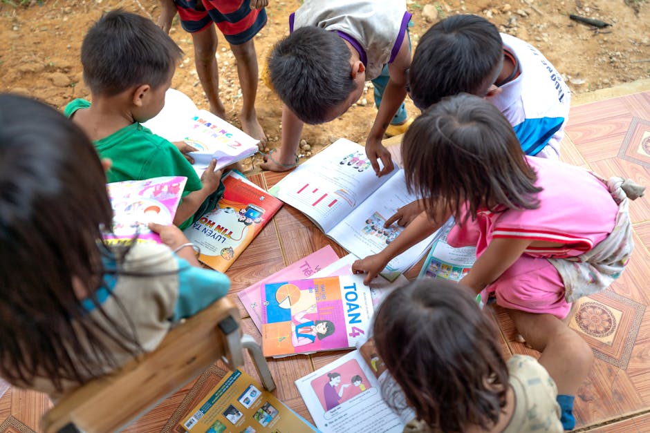 Group of children reading and studying together outdoors